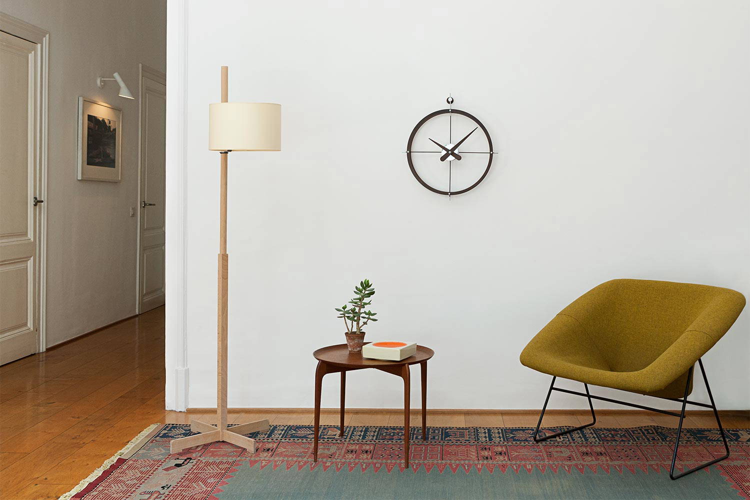 2 Puntos clock by Nomon hung in a living area 
