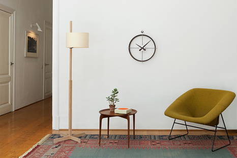 2 Puntos clock by Nomon hung in a living area 