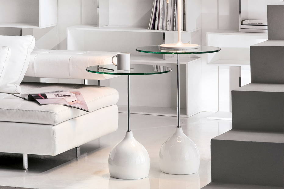 Adachi end tables with a glossy white base and clear glass top