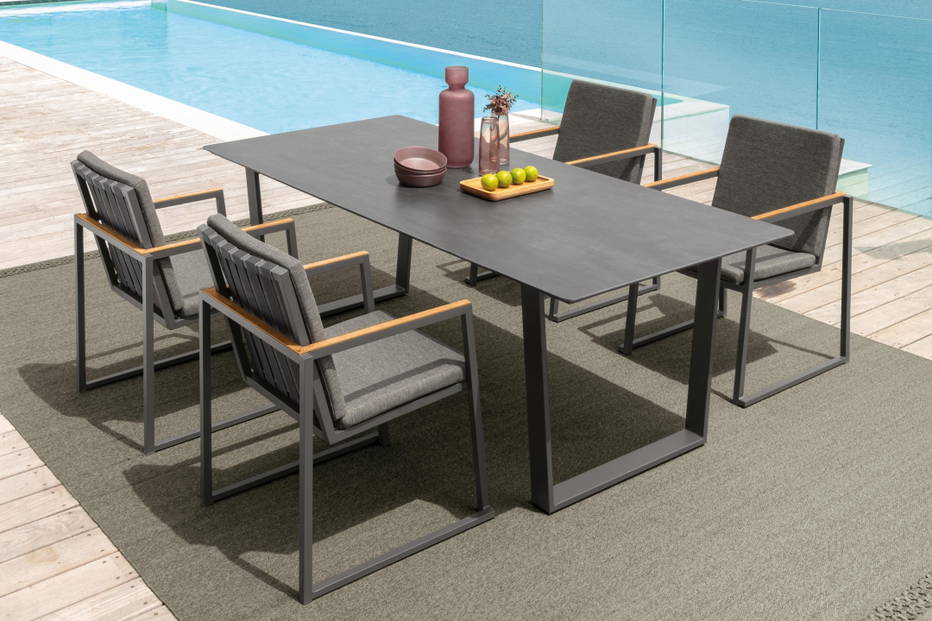 The Alabama Alu dining table with four Alabama Alu dining armchairs.