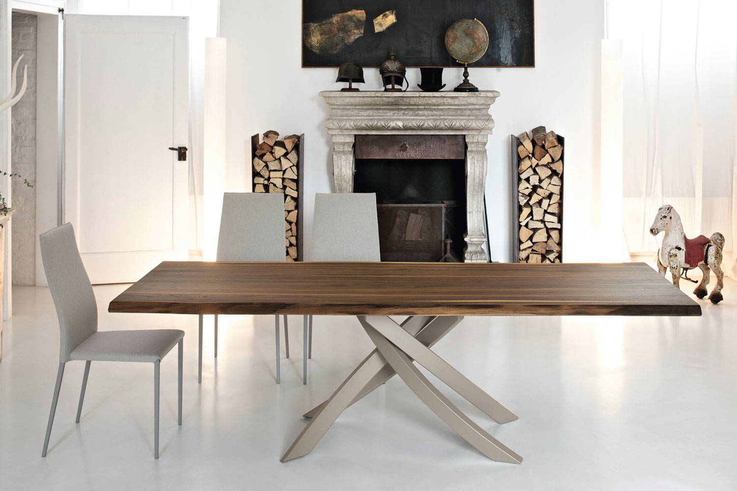 Artistico dining table with a solid walnut top and sand metal base