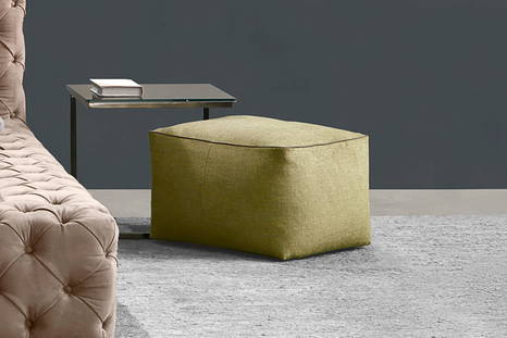 Stone pouf with leather piping 