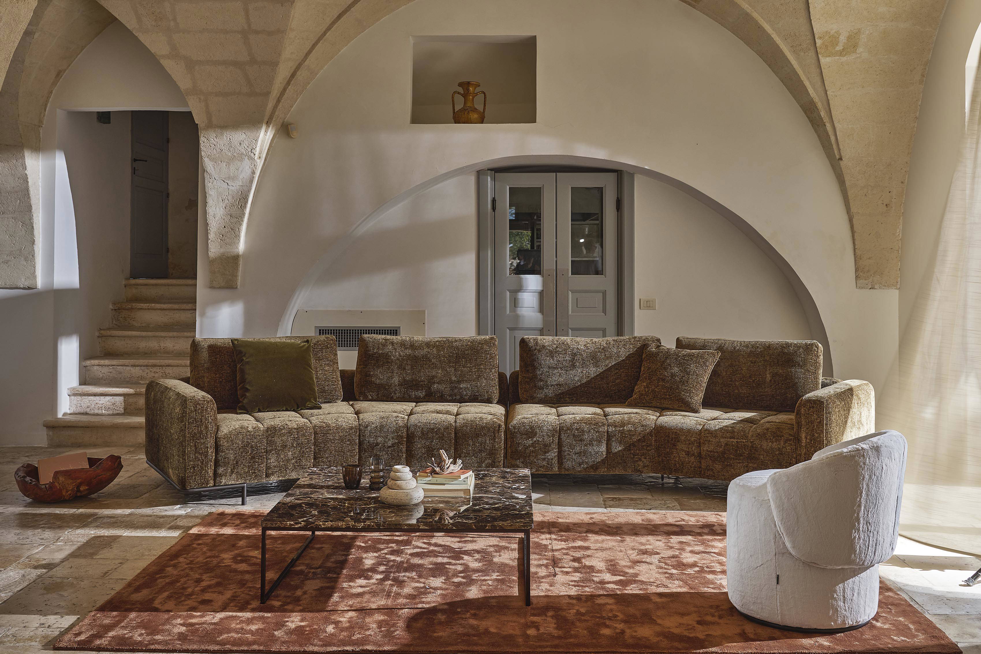 The Cortina Tufted Curved Sectional Sofa is made in Italy.