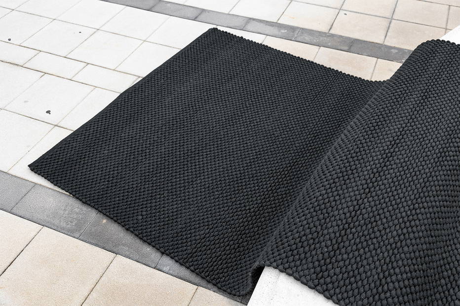 The Dakar rug pictured on a stone floor.