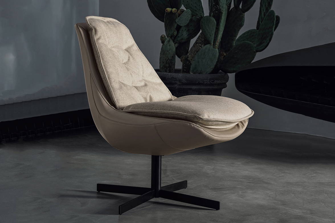Daya armchair features an upholstered shell and seat cushion Daya armchair features an upholstered shell and seat cushion