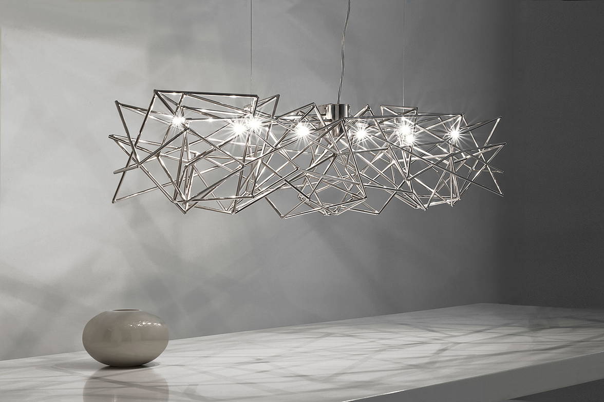 Etoile linear suspension by Terzani suspended over a dining table Etoile linear suspension by Terzani suspended over a dining table