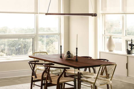 The Linea H Suspension Light in walnut and brass finishes.
