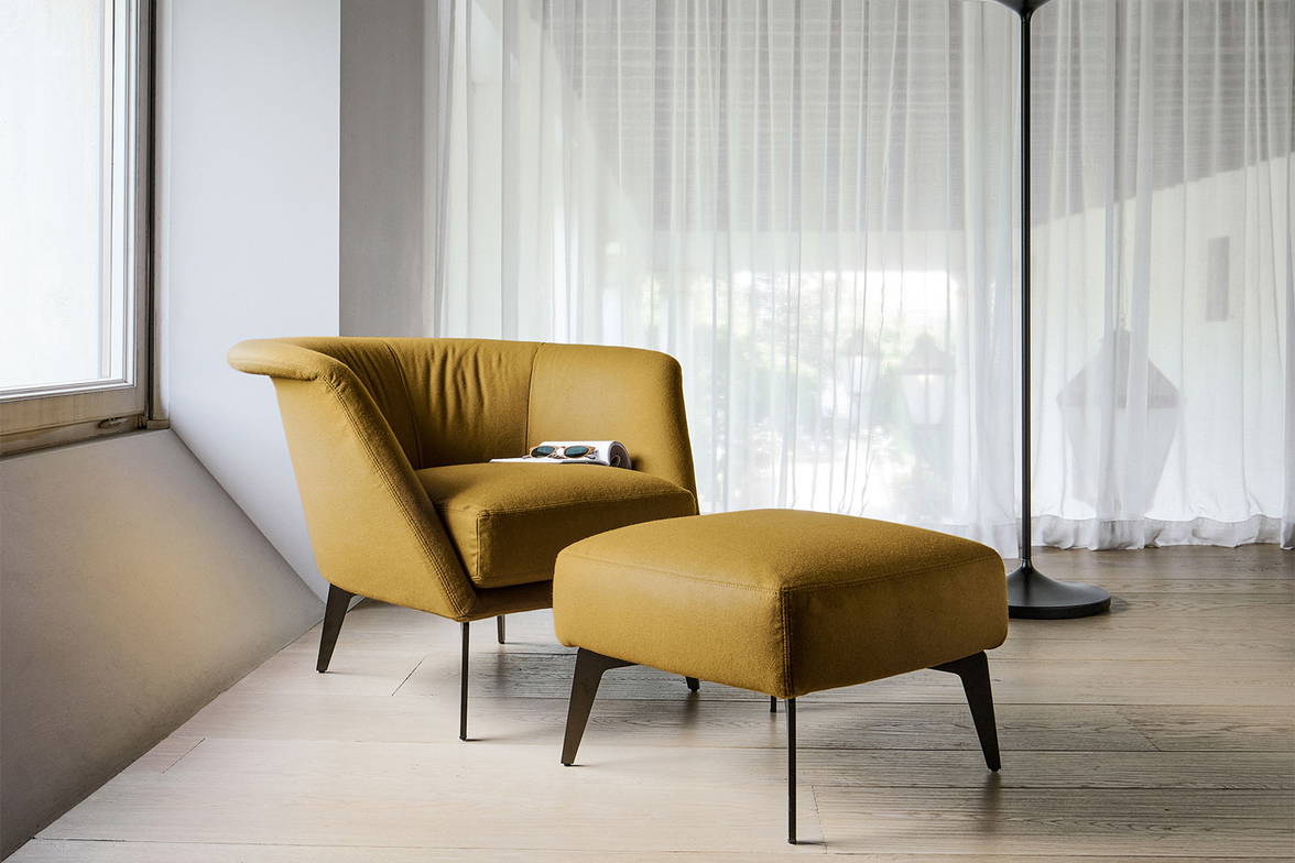 The Lovy low armchair with matching footstool. The Lovy low armchair with matching footstool.