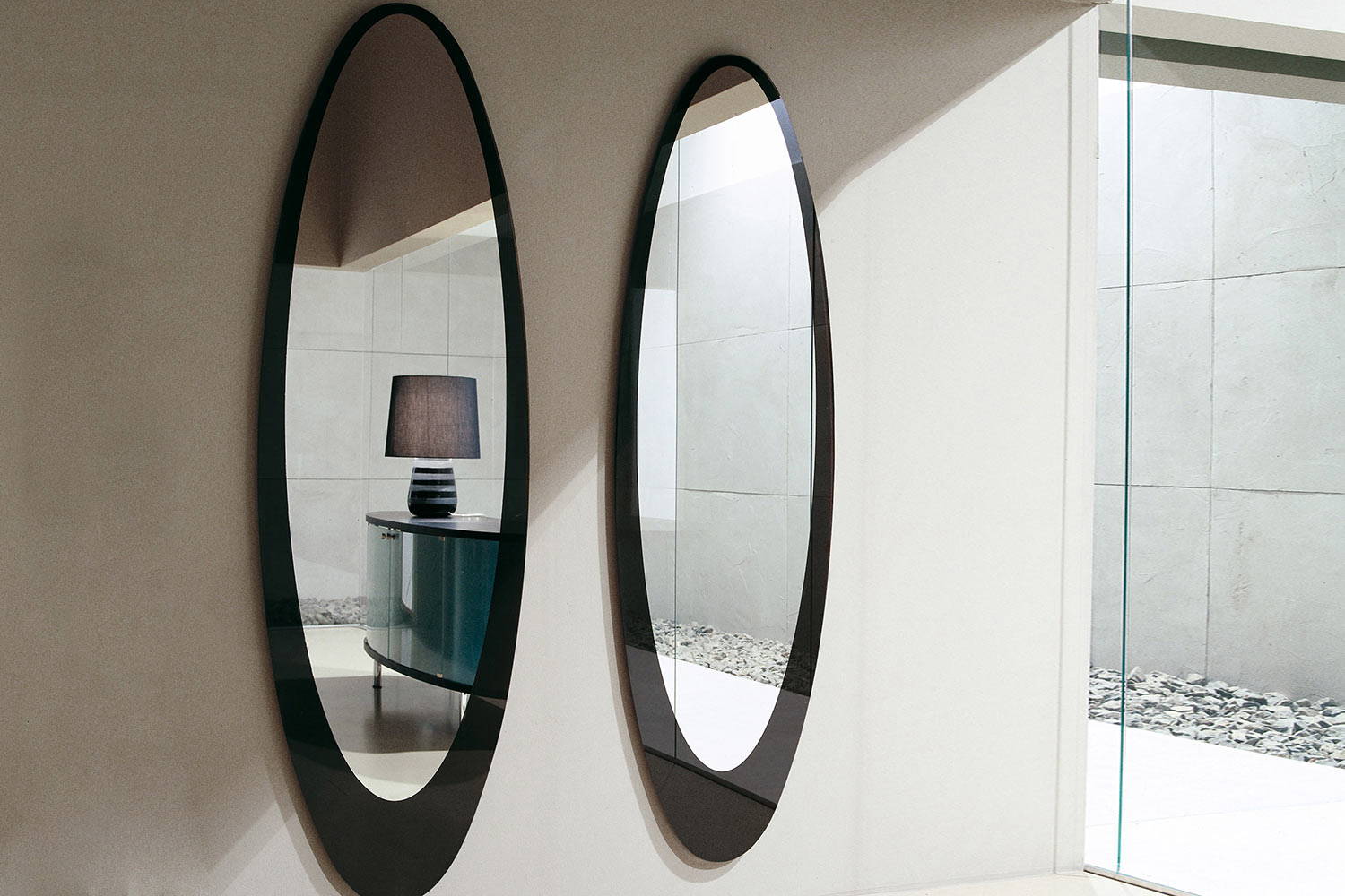 Olmi mirrors by Tonin Casa securely mounted to the wall 