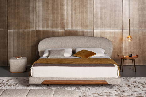 The Olos bed with the Olos pouf and the Olos bedside table.