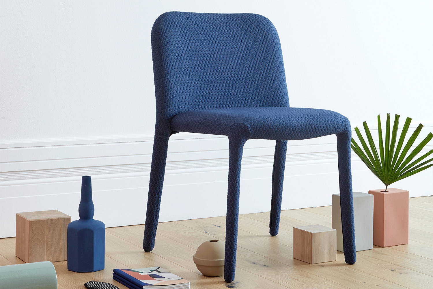 Pelè Dining Chair features a fully padded and upholstered metal frame