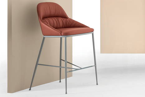 Queen bar stool features upholstered seating available in an array of fabrics, leathers, and ecoleathers
